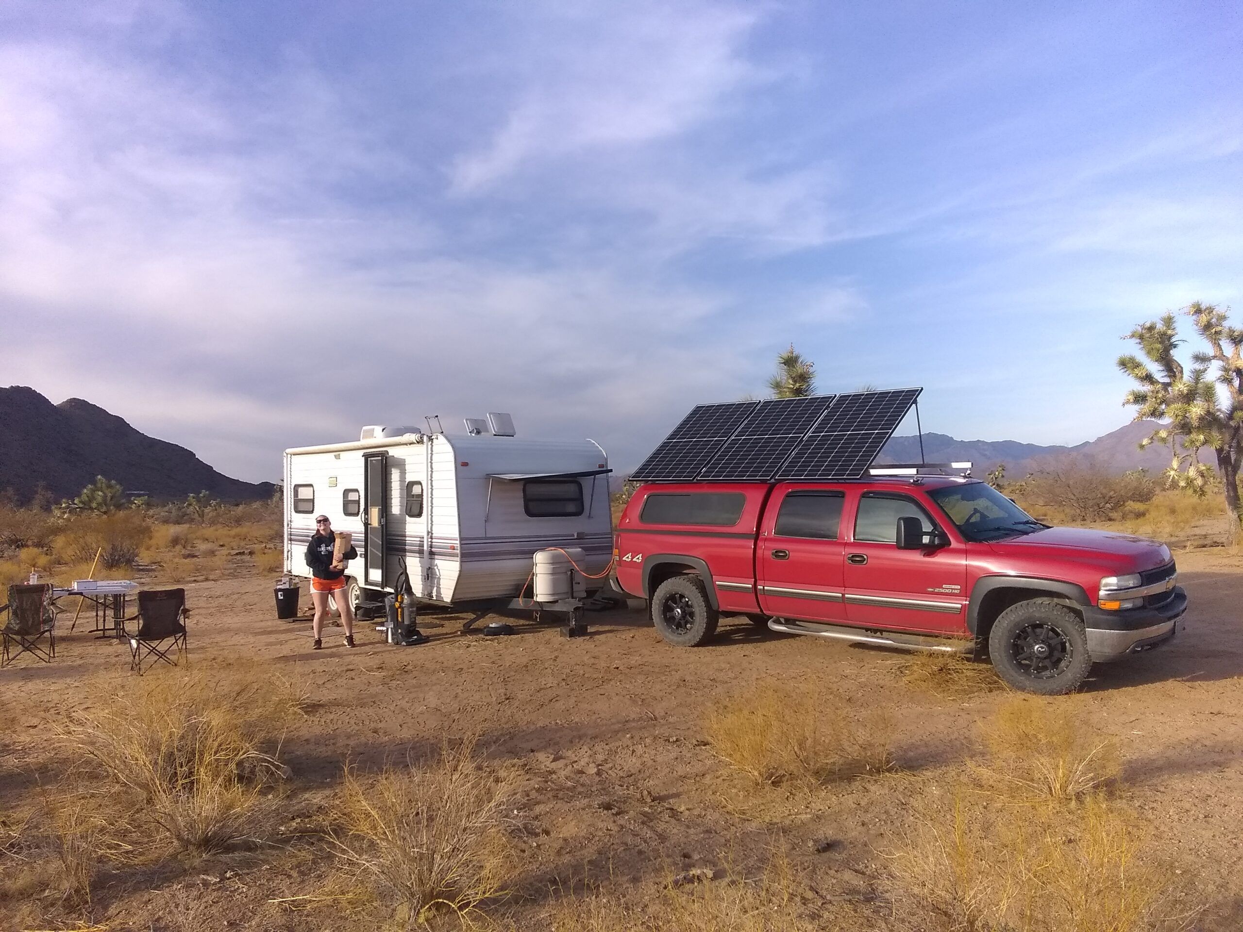 Picture of Boondocking setup including truck with solar panels on roof, and tow behind RV in Arizona.